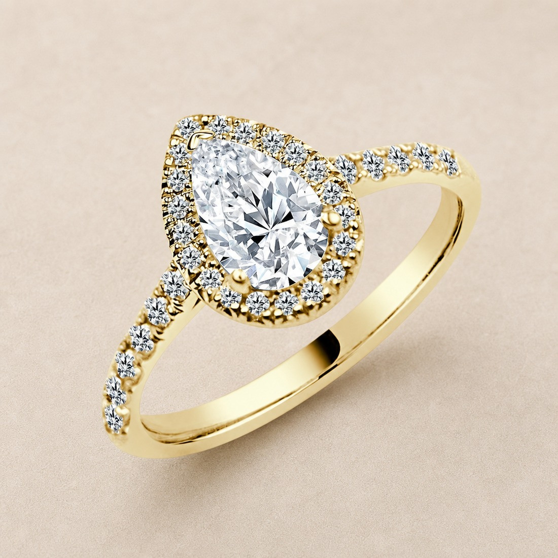 Solitario oro amarillo halo de talla pera · vista en tres cuartos, diamante natural 0,70 ct | Joyería Bellido
